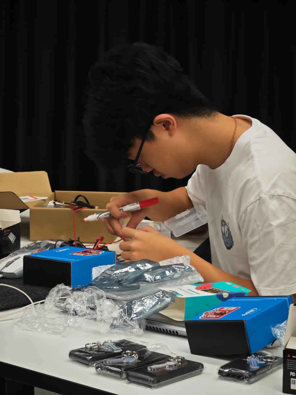 Student wiring up an electronics kit